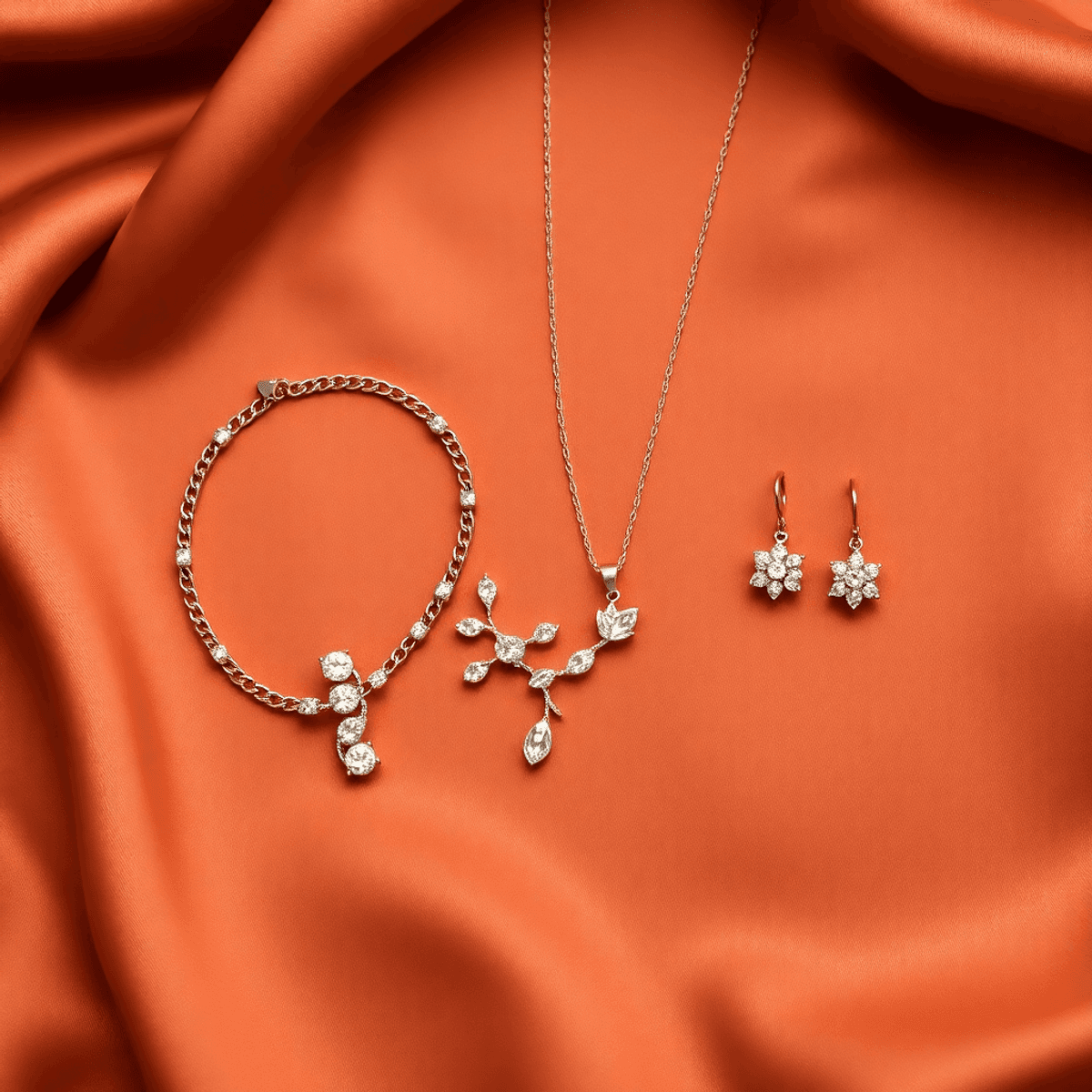 A flat lay of elegant jewelry pieces, including a bracelet, necklace, and earrings, arranged on luxurious fabric, conveying sophistication and warmth.